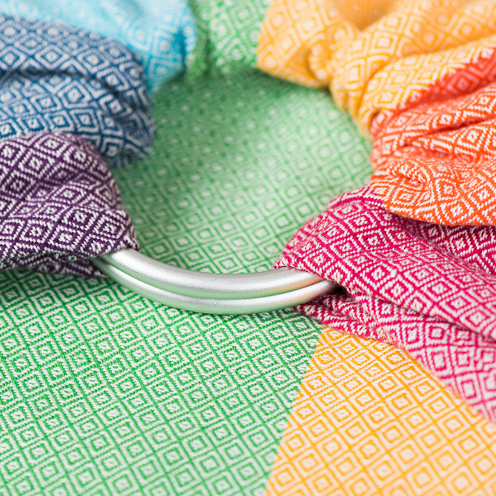 Ringsling Light Rainbow von Girasol mit silbernen Ringen auf farbenfrohem Stoff handgewebt 
